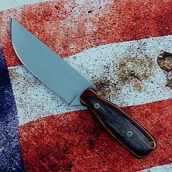 Knife 48 - drop point hunter with a polished 1095 steel blade. The Royal Jacaranda laminated wood scales with blue liners measure 4 1/2' long. The knife features file work on the spine, mosaic pins and a stainless steel lanyard hole. A kydex sheath with teklok spacing is included. $160.00 + $10.00 shipping and handling