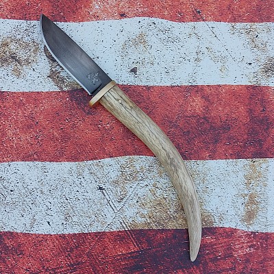 Knife 134 - drop point hunter with a blacked out 80CRV2 steel blade. The handle is made from a deer antler tine. The knife features a brass guard and brass pin. A kydex sheath with teklok spacing is included. $210.00 + $15.00 shipping and handling