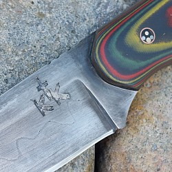 Knife 304 - San Mai drop point with a 1095 core and 80CRV2 steel outer cladding. The scales are crafted from Contra G-10. The knife features jimping on the spine, copper mosaic pins and a copper lanyard hole. The leather lined kydex sheath is included and is set up for both vertical and horizontal carry. $425.00 + $10.00 shipping and handling